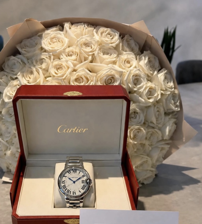 Luxury watch in gift box with white roses