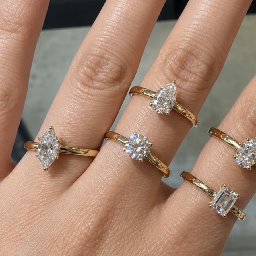 Gold solitaire rings worn on hand